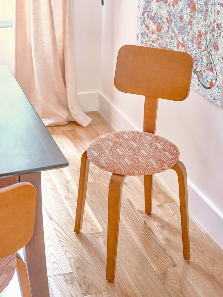 Mid-century bentwood dining chair with woven coral pattern seat on light wood floors. Interior design by Tenlie Mourning